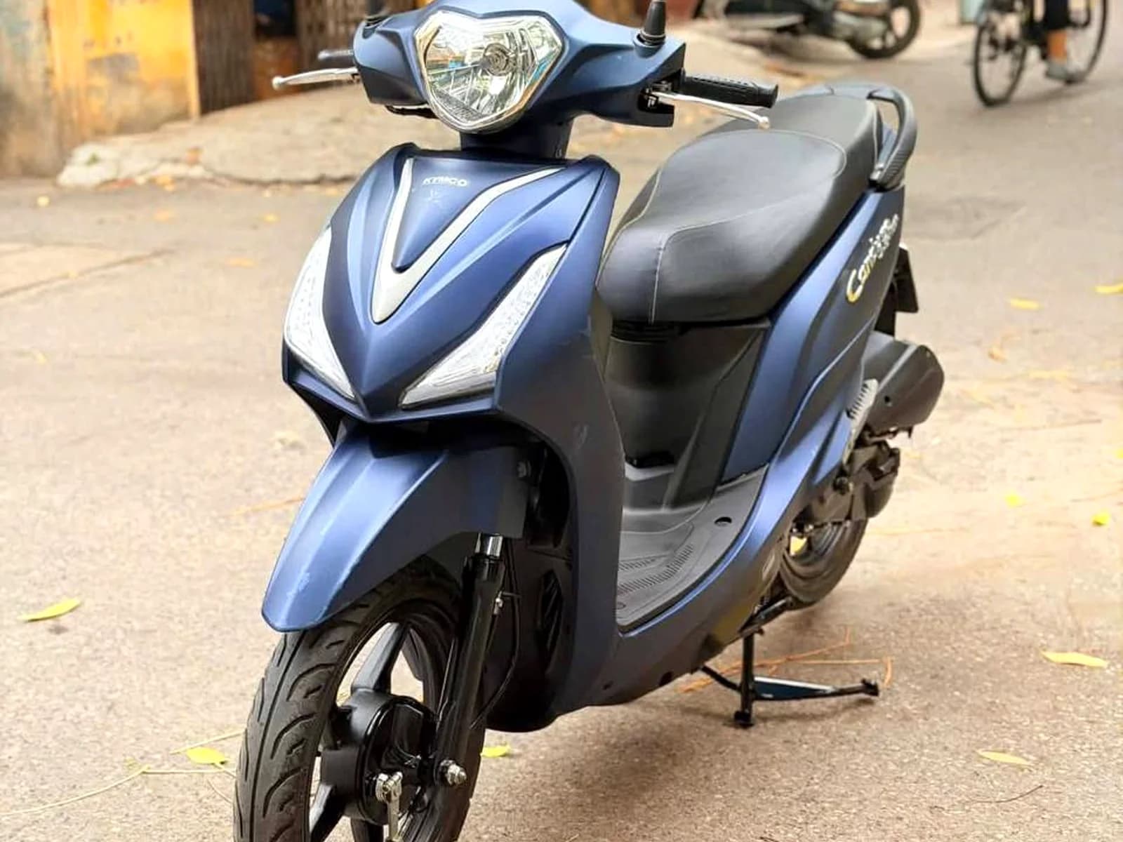 Blue Kymco Candy 50cc scooter from the UNIQ Moto fleet on a street